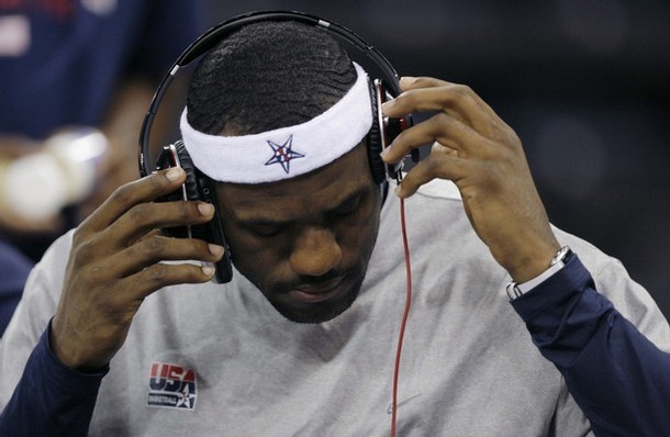 U.S. basketball team player LeBron James takes off his headphones